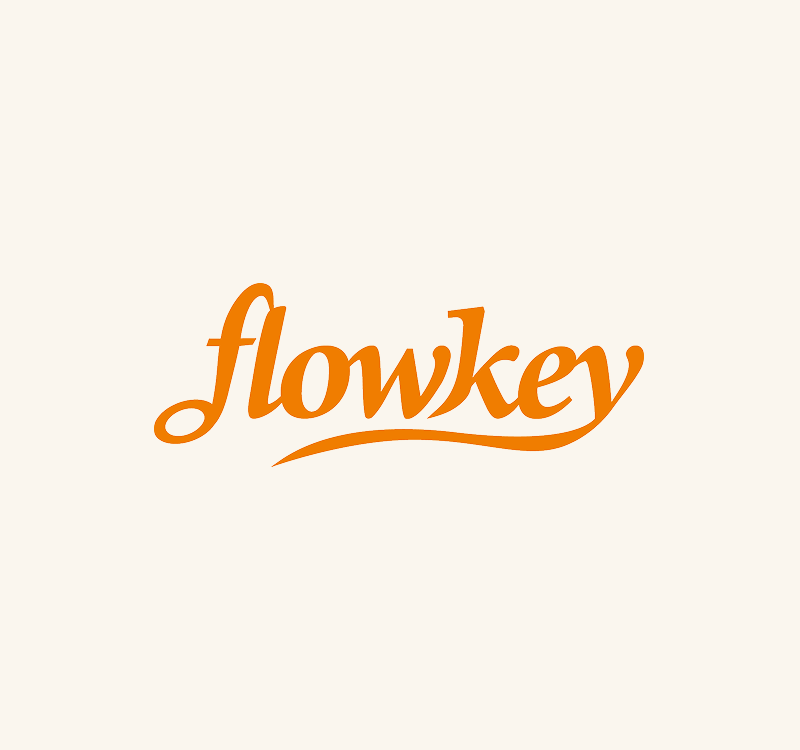 The word "flowkey" in orange cursive lettering on a light beige background.