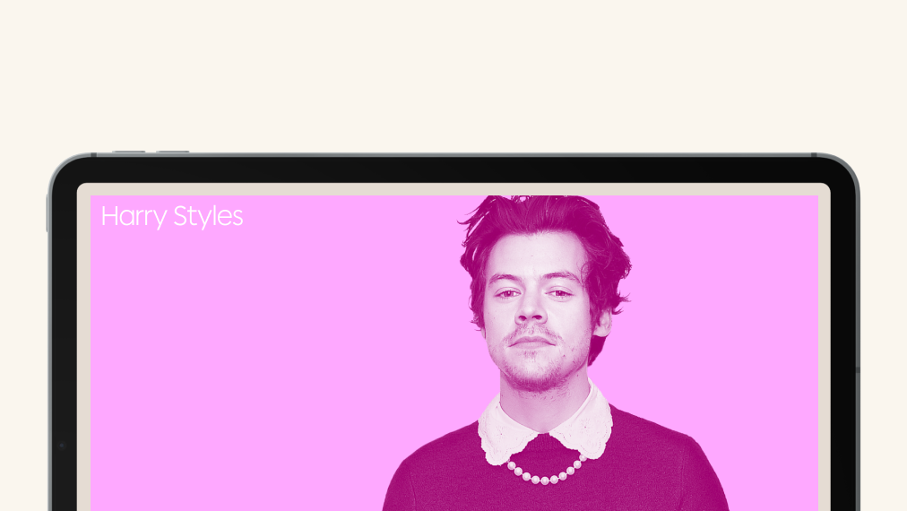 A tablet screen displaying a stylized portrait of a person with dark hair, wearing a collared shirt and pearl necklace, against a pink background. The name "Harry Styles" appears in white text in the upper left corner.