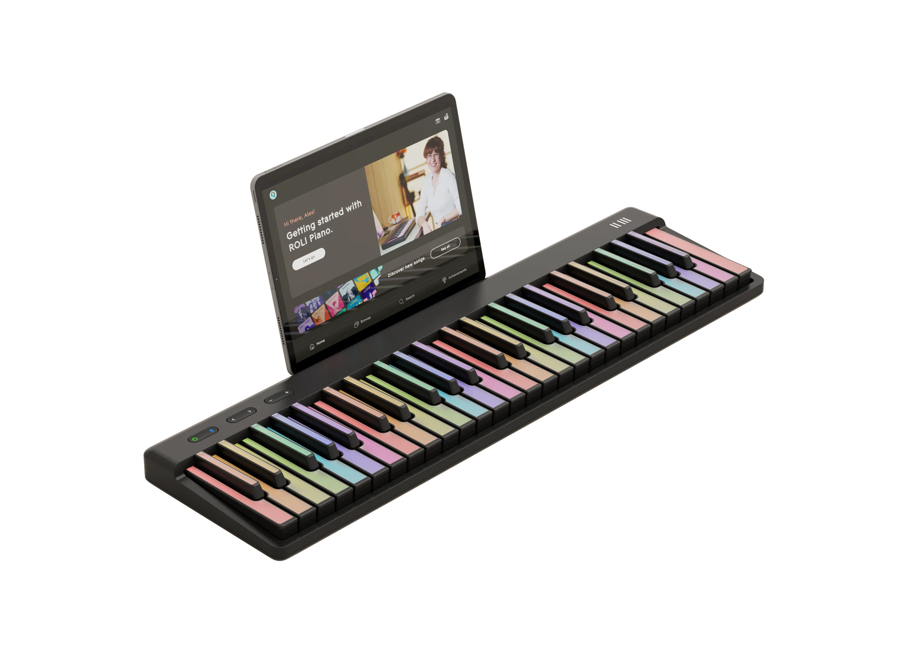 A ROLI Piano with pastel-colored keys sits on a surface, with a tablet displaying the ROLI Learn app propped up behind it.